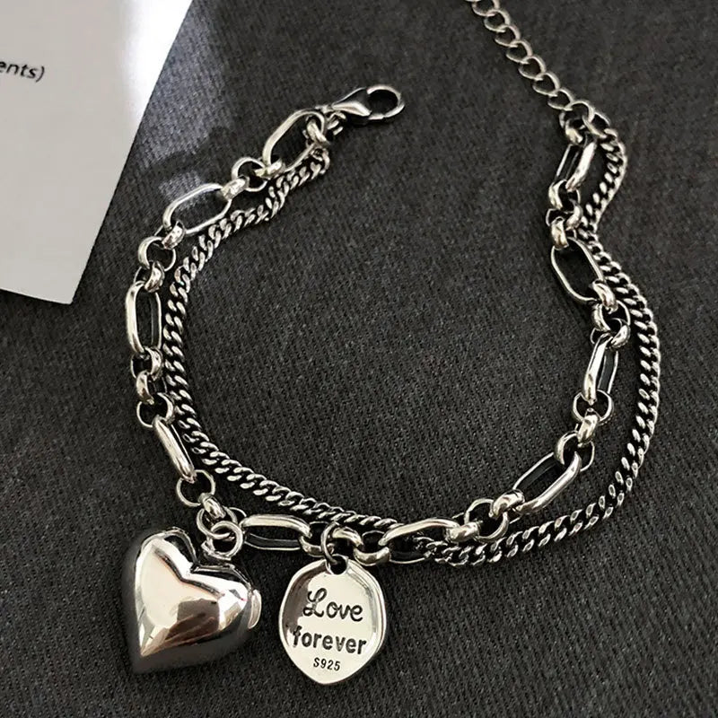 Sterling silver heart charm bracelet with ‘Love forever’ engraved tag”