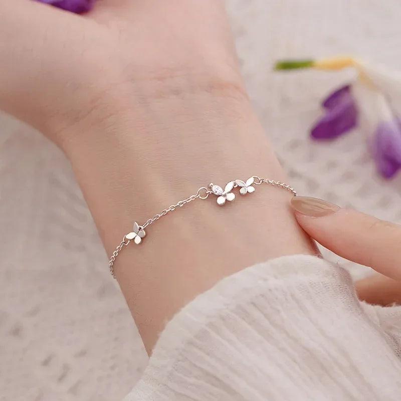 Minimalist silver chain bracelet with dainty butterfly charms