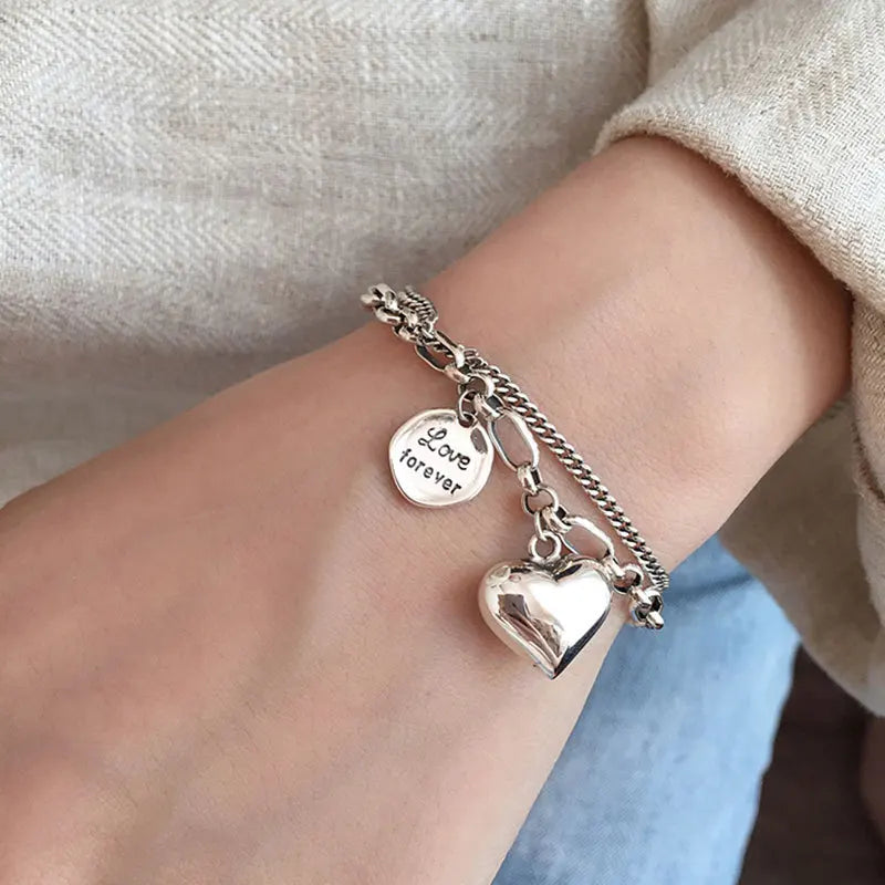 Sterling silver heart charm bracelet with ‘Love forever’ engraved tag”