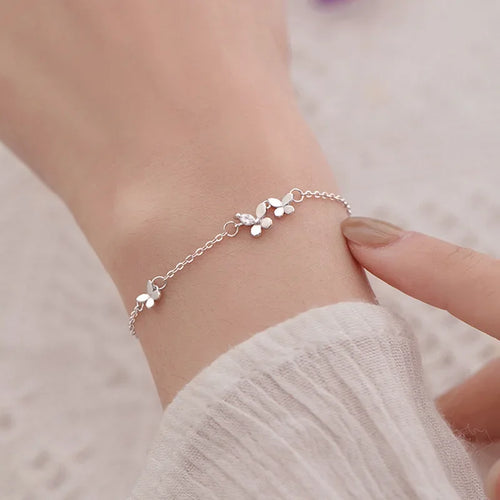 Minimalist silver chain bracelet with dainty butterfly charms