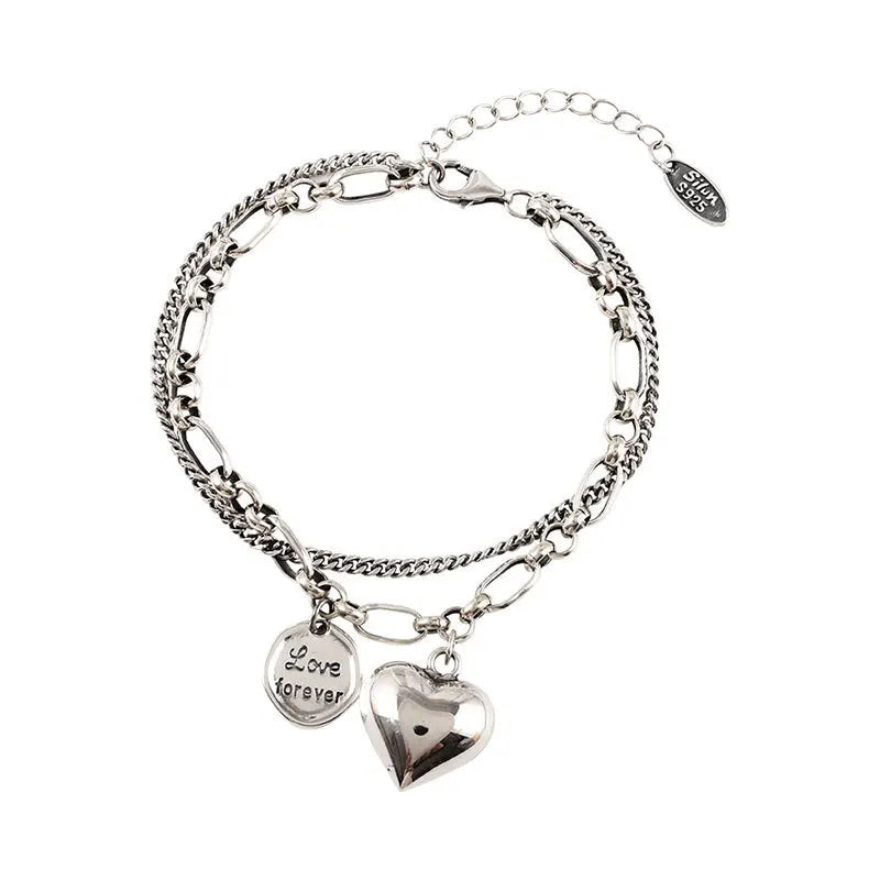 Sterling silver heart charm bracelet with ‘Love forever’ engraved tag”