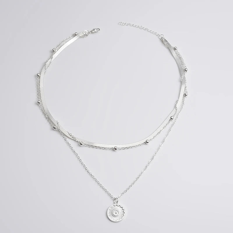 Layered silver necklace set with sun pendant and minimalist chains