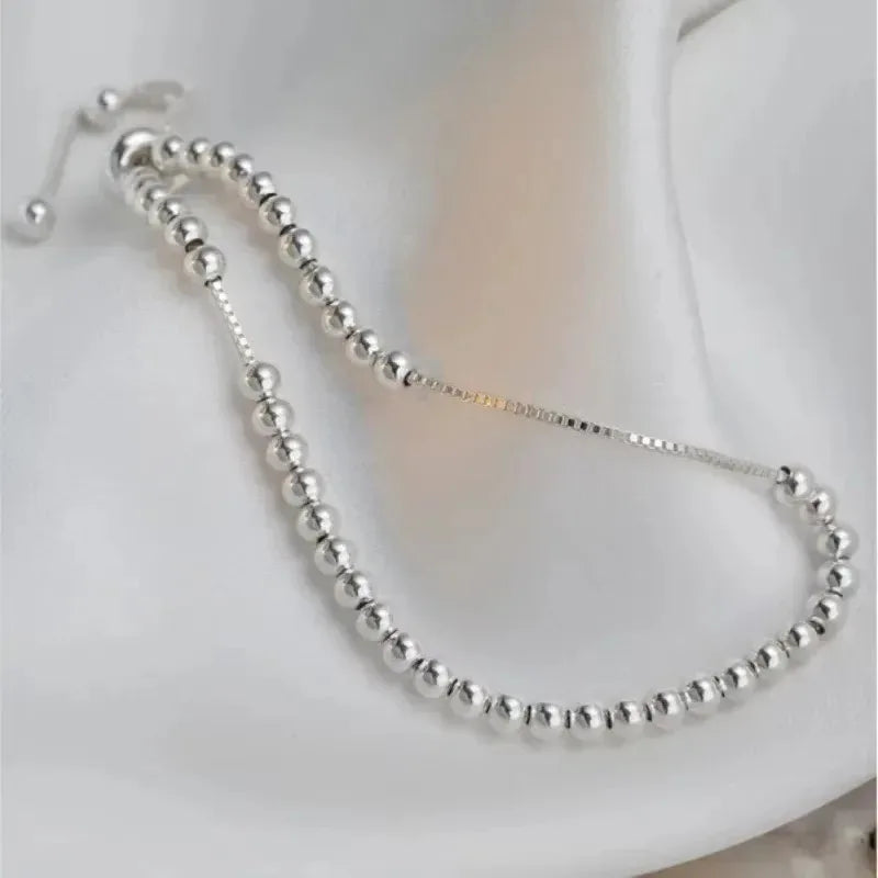 “Adjustable silver bead bracelet with sliding clasp minimalist design