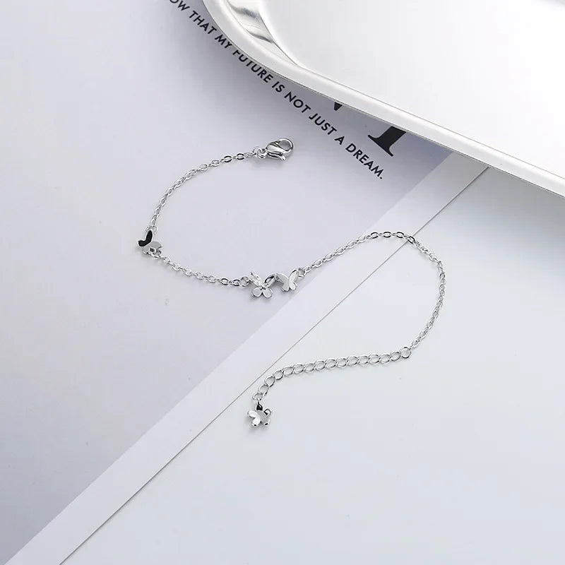 Minimalist silver chain bracelet with dainty butterfly charms