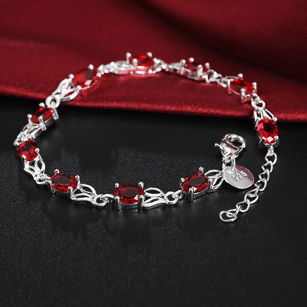 Silver plated bracelet with ruby red gemstones – elegant filigree design