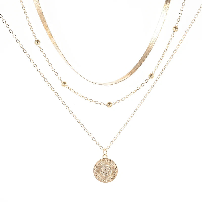 Layered silver necklace set with sun pendant and minimalist chains