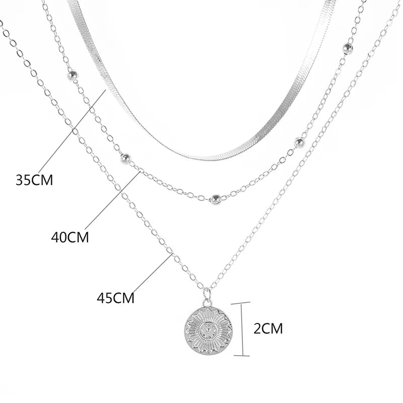 Layered silver necklace set with sun pendant and minimalist chains