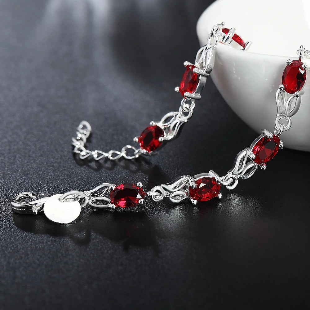 Silver plated bracelet with ruby red gemstones – elegant filigree design