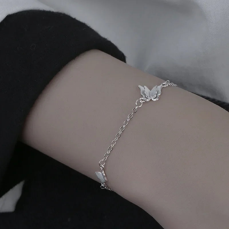 Minimalist silver chain bracelet with dainty butterfly charms