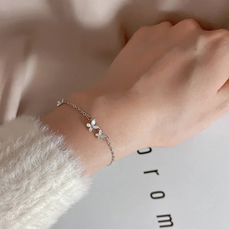 Minimalist silver chain bracelet with dainty butterfly charms