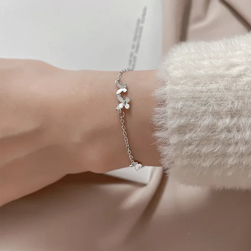 Minimalist silver chain bracelet with dainty butterfly charms