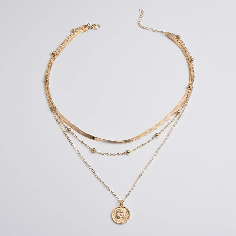 Layered silver necklace set with sun pendant and minimalist chains