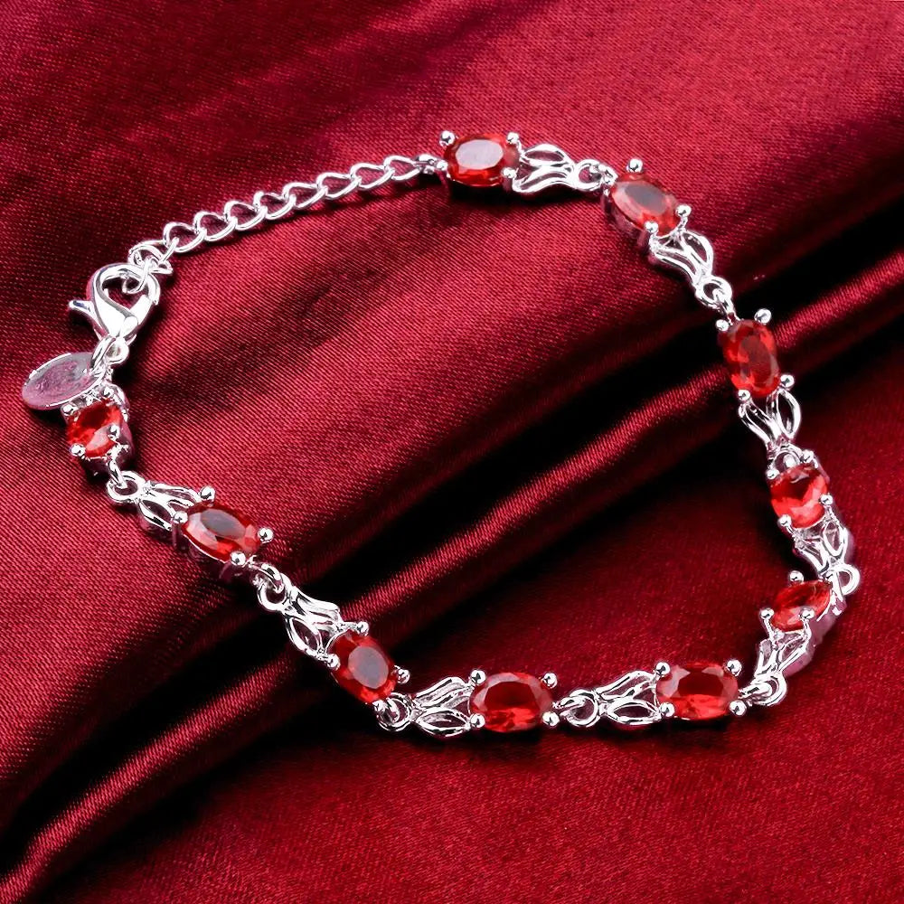 Silver plated bracelet with ruby red gemstones – elegant filigree design
