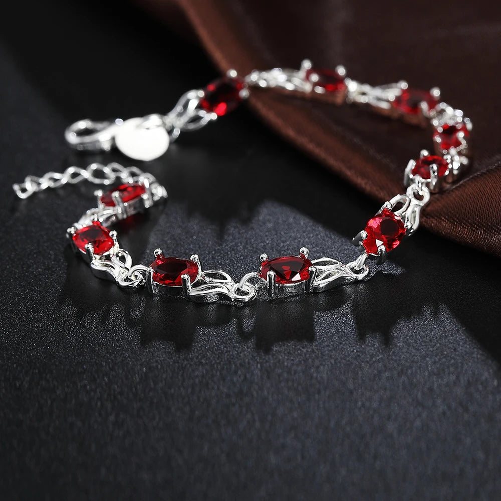 Silver plated bracelet with ruby red gemstones – elegant filigree design