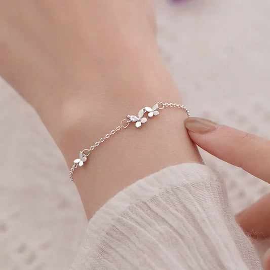 Minimalist silver chain bracelet with dainty butterfly charms