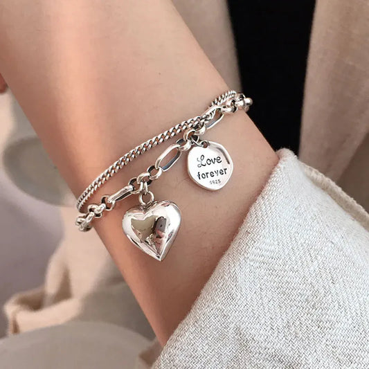 Sterling silver heart charm bracelet with ‘Love forever’ engraved tag”