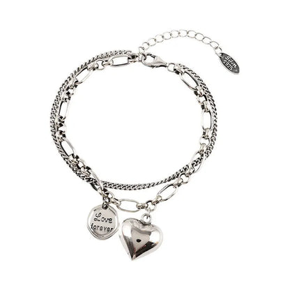 Sterling silver heart charm bracelet with ‘Love forever’ engraved tag”