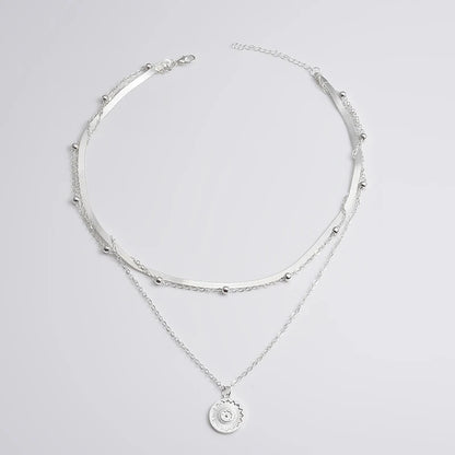 Layered silver necklace set with sun pendant and minimalist chains