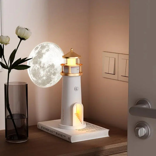 Lighthouse lamp and 3D moon night light on bedside table with vase and book