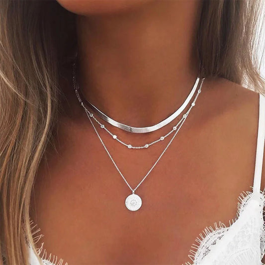 Layered silver necklace set with sun pendant and minimalist chains