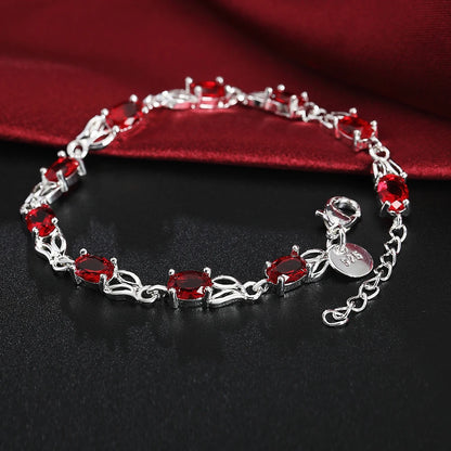 Silver plated bracelet with ruby red gemstones – elegant filigree design