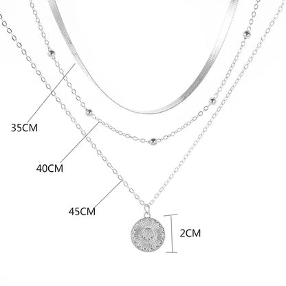 Layered silver necklace set with sun pendant and minimalist chains