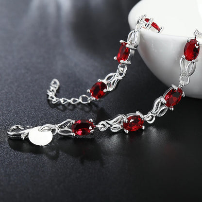Silver plated bracelet with ruby red gemstones – elegant filigree design