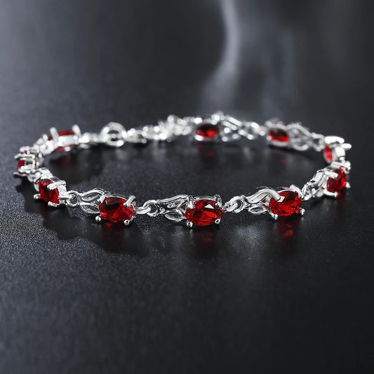 Silver plated bracelet with ruby red gemstones – elegant filigree design