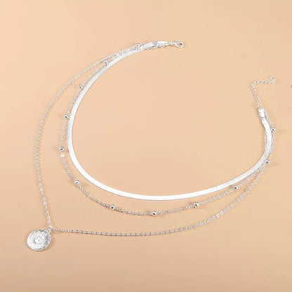 Layered silver necklace set with sun pendant and minimalist chains