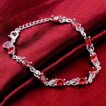 Silver plated bracelet with ruby red gemstones – elegant filigree design